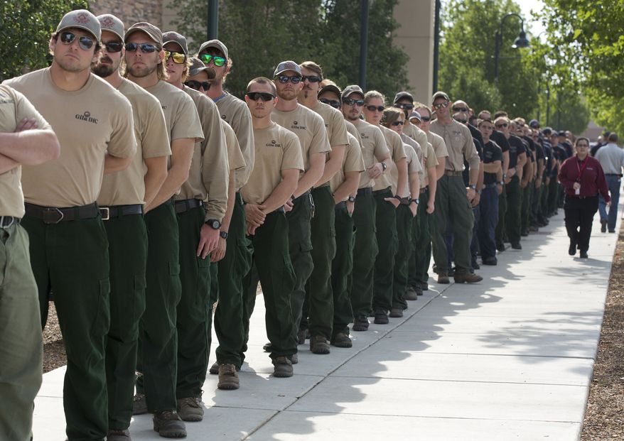 The Gila Interagency Hot Shot Crew from New Mexico lines up outside Tim's Toyota Center along with Hotshot crews from other states on July 9, 2013 in Prescott, Ariz. Thousands of firefighters gathered at the center along with Vice President Joseph R. Biden and other dignitaries and family members of the 19 fallen Granite Mountain Hotshots for a memorial service honoring the 19 who were killed battling a blaze near Yarnell, Ariz. last week. (Associated Press)