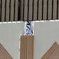 This photo was taken on Thursday, June 20, 2013, shows the Taliban flag visible through a gap in a wall of the new office of the Afghan Taliban in Doha, Qatar, after the opening of the office several days ago. (AP Photo/Osama Faisal)