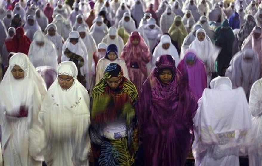 Muslim women perform an evening prayer called &quot;tarawih,&quot; marking the first eve of the holy fasting month of Ramadan, at a mosque in Denpasar, Bali, Indonesia, on Tuesday, July 9, 2013. During Ramadan, the holiest month in Islamic calendar, Muslims refrain from eating, drinking, smoking and sex from dawn to dusk. Fasting during Ramadan is one of the Five Pillars of Islam. (AP Photo/Firdia Lisnawati) ** FILE **