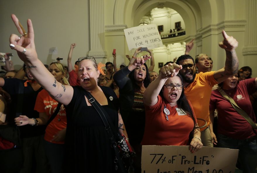 Opponents of HB 2, an abortion bill, yell outside the Texas House after the bill is provisionally approved on July 9, 2013, in Austin, Texas. The bill would require doctors to have admitting privileges at nearby hospitals, only allow abortions in surgical centers, dictate when abortion pills are taken and ban abortions after 20 weeks. (Associated Press)