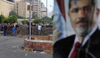 Supporters of ousted Egyptian President Mohammed Morsi protest as army soldiers guard at the Republican Guard building in Nasr City in Cairo on July 10, 2013. (Associated Press)