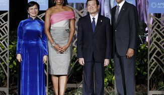 **FILE** President Obama and first lady Michelle Obama greet Vietnamese President Truong Tan Sang and wife Mai Thi Hanh before the APEC leaders dinner in Honolulu on Nov. 12, 2011. (Associated Press)