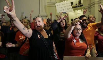 Opponents of HB 2, an abortion bill, yell outside the Texas House after the bill is provisionally approved on July 9, 2013, in Austin, Texas. The bill would require doctors to have admitting privileges at nearby hospitals, only allow abortions in surgical centers, dictate when abortion pills are taken and ban abortions after 20 weeks. (Associated Press)