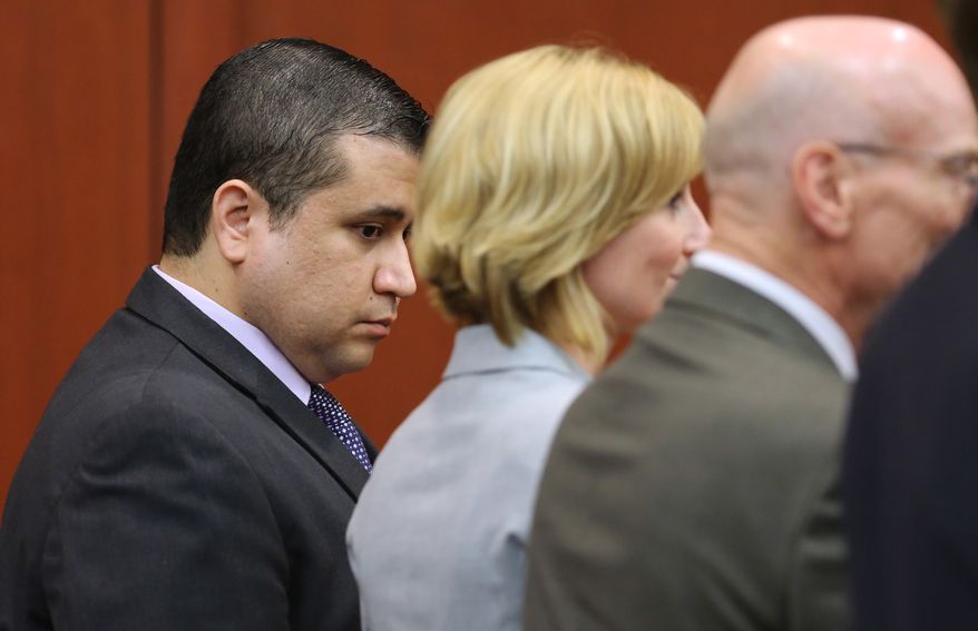 ** FILE ** George Zimmerman looks down as he stands next to defense co-counsels (from second from left) Lorna Truett, Don West and Mark O'Mara as Mr. Zimmerman is found not guilty in the Seminole Circuit Court in Sanford, Fla., on Saturday, July 13, 2013. Mr. Zimmerman was cleared of all charges in the shooting death of Trayvon Martin, the unarmed black teenager whose killing unleashed a furious debate across the U.S. over racial profiling, self-defense and equal justice. (AP Photo/Orlando Sentinel, Joe Burbank, Pool)