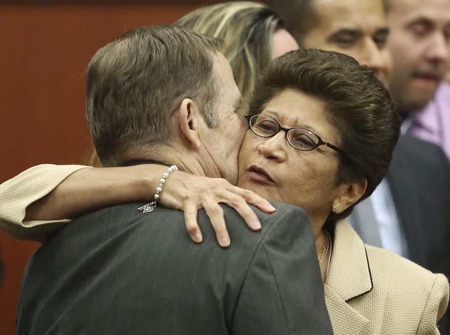 Robert Zimmerman Sr. and Gladys Zimmerman embrace following their son George Zimmerman's acquittal in Seminole Circuit Court in Sanford, Fla. on Saturday, July 13, 2013. (AP Photo/Gary W. Green, Pool)