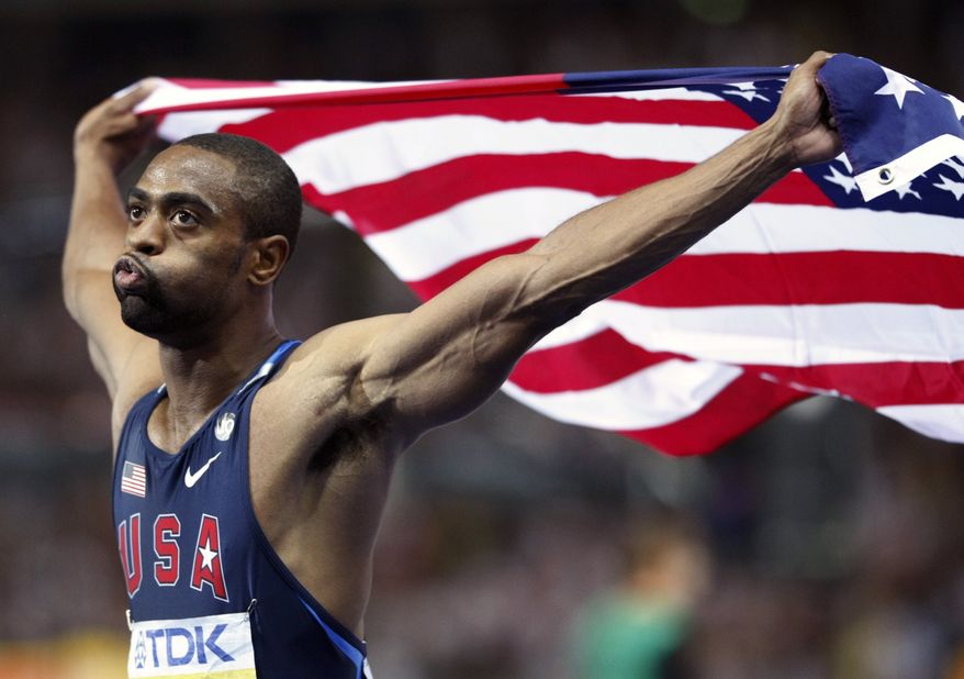 FILE - In this Aug. 16, 2009 file photo, United States' Tyson Gay who placed second celebrates with the U.S. flag after the Men's 100m final during the World Athletics Championships in Berlin. Gay said Sunday, July 14, 2013 that he tested positive for a banned substance and that he will pull out of the world championships next month in Moscow. (AP Photo/Anja Niedringhaus, File)