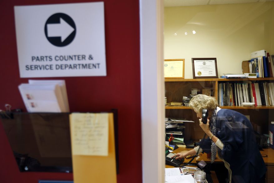 June Springer, an office receptionist who just turned 90, answers a phone at Caffi Contracting Services in Alexandria, Va., on Friday, July 12, 2013. (AP Photo/Alex Brandon)