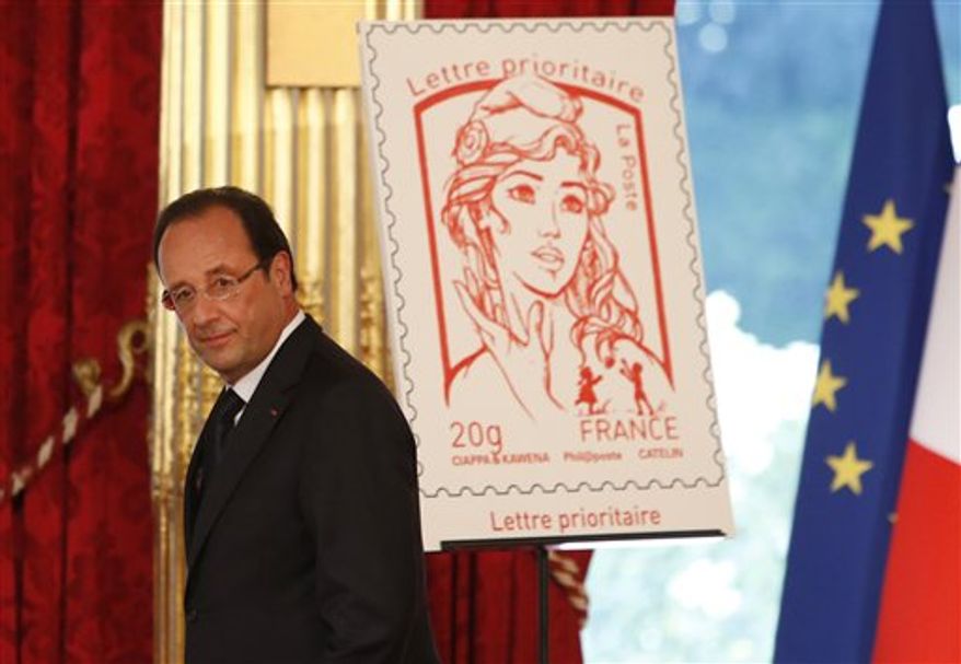 French President Francois Hollande stands next to the newly unveiled official Marianne postage stamp at the Elysee Palace during the Bastille Day celebrations in Paris. (AP Photo/Francois Mori, File)