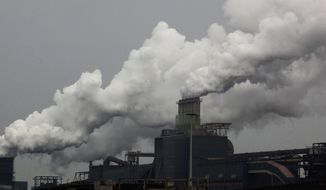 Emissions pour from The Corus steel plant in the Netherlands. The European Union’s cap-and-trade emissions trading scheme, while more affordable than the carbon tax, has run into problems of its own, as the early “market” for polluting rights proved badly out of whack, sending designers back to the drawing board. (Associated Press)