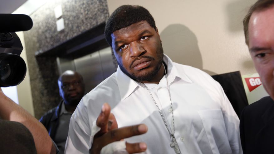 FILE - In this Dec. 18, 2012 file photo, Dallas Cowboys defensive tackle Josh Brent, center, and his attorney George Miller, obscured at right, leave court in Dallas. Brent says he is retiring from football as he faces trial for a fatal crash that killed a teammate. Brent's agent, Peter Schaffer, said Thursday, July 18, 2013, that the 25-year-old Brent was "taking care of his priorities." (AP Photo/David Woo, Pool, File)