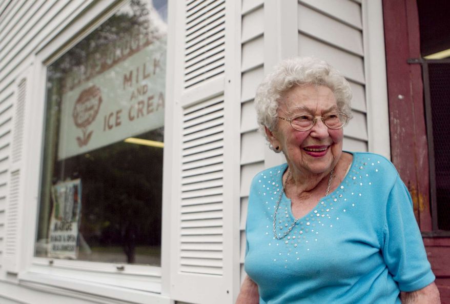 Margaretta Wolf, 96, stands in front of Wolf's Groceries in Marshfield, Tuesday, July 16, 2013, the day after an attempted robbery at knifepoint happened at her store. The masked man ordered Wolf to open the cash register. She told him he could have all the Tootsie Rolls he wanted, but she wasn't going to open the register, and stood her ground when the would-be robber flashed his knife. (AP Photo/News-Herald, Megan Mccormick)