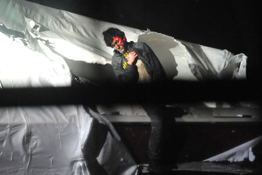Dzhokhar Tsarnaev emerges from the boat, a laser from a sniper&#39;s rifle illuminating his forehead. (Sgt. Sean Murphy)