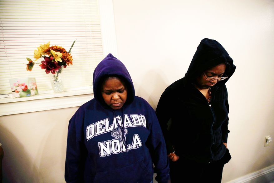 Loretta Powell (left) and Tyra Forrest take part in a “Hoodie Sabbath” at the New St. Mark Baptist Church in New Orleans in reaction to George Zimmerman’s acquittal in the death of Trayvon Martin. Some black Americans, however, are calling for a cooling of tensions. (Associated Press) ** FILE **