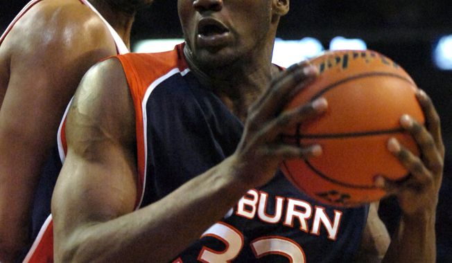 **FILE** Auburn's Korvotney Barber (32) looks toward the basket as Arkansas' Darian Townes, left, defends during the first half of a college basketball game in Fayetteville, Ark., Wednesday, Feb. 7, 2007. (AP Photo/April L. Brown)