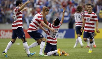 Teammates celebrate with United States&#39; Joe Corona (6) after he scored a goal against El Salvador during the first half in the quarterfinals of the CONCACAF Gold Cup soccer tournament on Sunday, July 21, 2013, in Baltimore. (AP Photo/Patrick Semansky)