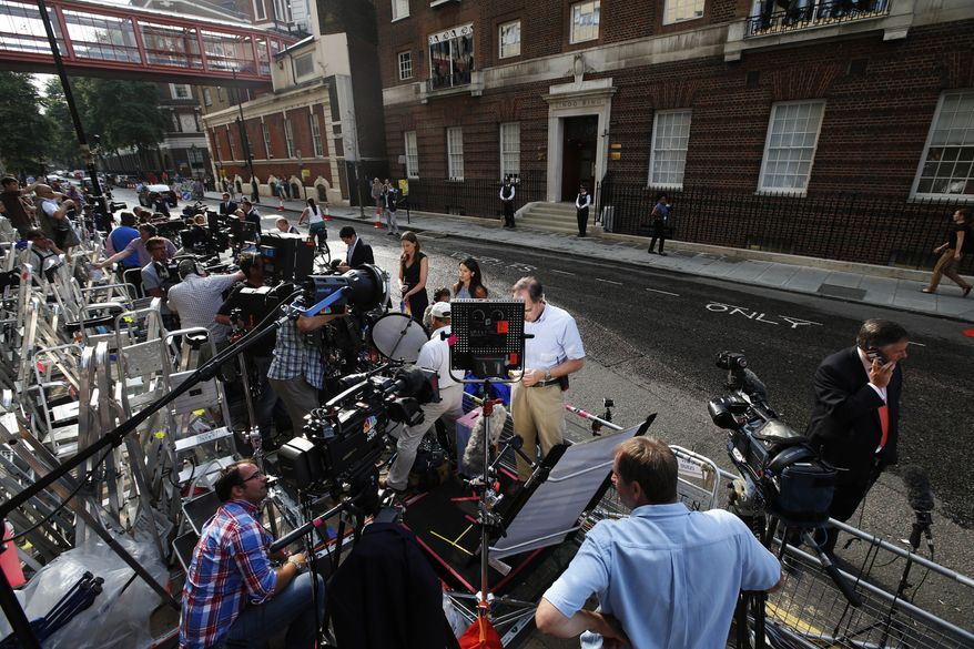 Members of the media gather across St. Mary's Hospital exclusive Lindo Wing in London, Monday, July 22, 2013. Buckingham Palace officials say Prince William's wife, Kate, has been admitted to the hospital in the early stages of labour. Royal officials said that Kate traveled by car to St. Mary's Hospital in central London. Kate _ also known as the Duchess of Cambridge _ is expected to give birth in the private Lindo Wing of the hospital, where Princess Diana gave birth to William and his younger brother, Prince Harry.The baby will be third in line for the British throne _ behind Prince Charles and William _ and is anticipated eventually to become king or queen. (AP Photo/Lefteris Pitarakis)