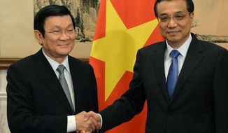 Vietnamese President Truong Tan Sang (left, shown here with Chinese Premier Li Keqiang in June) will meet with President Obama while suppressing dissidents, bloggers and religious leaders. (AP Photo/Mark Ralston, Pool)