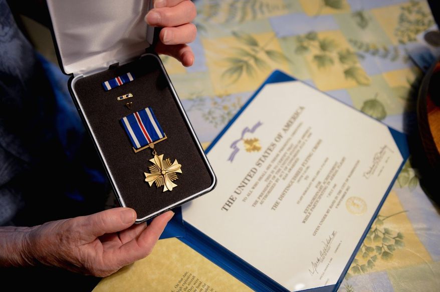"If you've got a job to do, you've got a job to do," says Millard "Lefty" Palmer of the daring maneuver with unexploded bombs stuck in his plane near the end of World War II. "Just do it, get it done, and then worry about other things." Sixty-seven years later, he received a Distinguished Flying Cross (with valor) from Rep. Gerald E. Connolly.
(Andrew Harnik/The Washington Times)