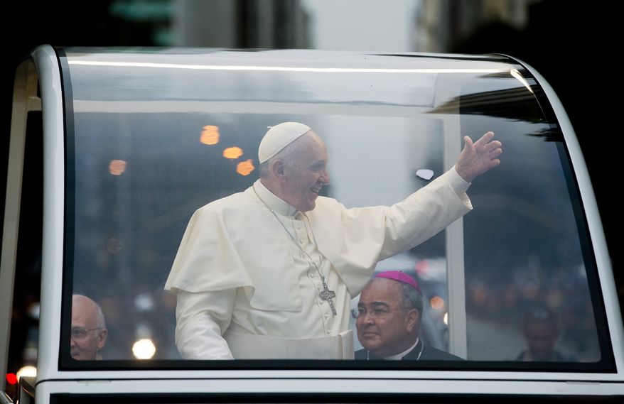 Pope Francis waves as he rides in his popemobile in Rio de Janeiro, Brazil, Monday July 22, 2013. The pontiff arrived for a seven-day visit in Brazil, the world's most populous Roman Catholic nation. During his visit, Francis will meet with legions of young Roman Catholics converging on Rio for the church's World Youth Day festival. (AP Photo/Victor R. Caivano)