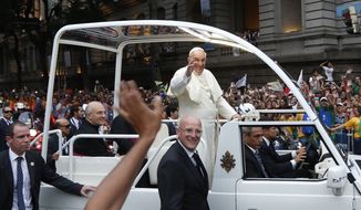 Pope Francis waves from his popemobile as he makes his way into central Rio de Janeiro, Brazil, Monday, July 22, 2013. The pontiff arrived for a seven-day visit in Brazil, the world&#39;s most populous Roman Catholic nation. (AP Photo/Victor R. Caivano) **FILE**