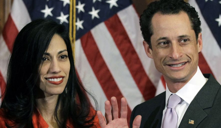 FILE - In this Jan. 5, 2011, file photo, Anthony Weiner and his wife Huma Abedin pose for photographs after the ceremonial swearing in of the 112th Congress on Capitol Hill in Washington. Abedin, who was notably absent five months later when Weiner resigned his congressional seat and admitted sending lewd Twitter photos to women, has been a key player in his surging mayoral run. She’s appeared in his campaign launch video, raised tens of thousands of dollars and joined him on the campaign trail. (AP Photo/Charles Dharapak, File)