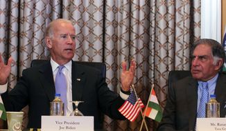 U.S. Vice President Joseph R. Biden (left) gestures as he speaks while Ratan Tata, former chairman of the Tata group, looks on during a meeting in Mumbai on Wednesday, July 24, 2013. Mr. Biden arrived in India on Monday on a trip that is focusing on boosting trade and regional security ties and strengthening a strategic partnership that has languished in recent years. (AP Photo/Rafiq Maqbool)
