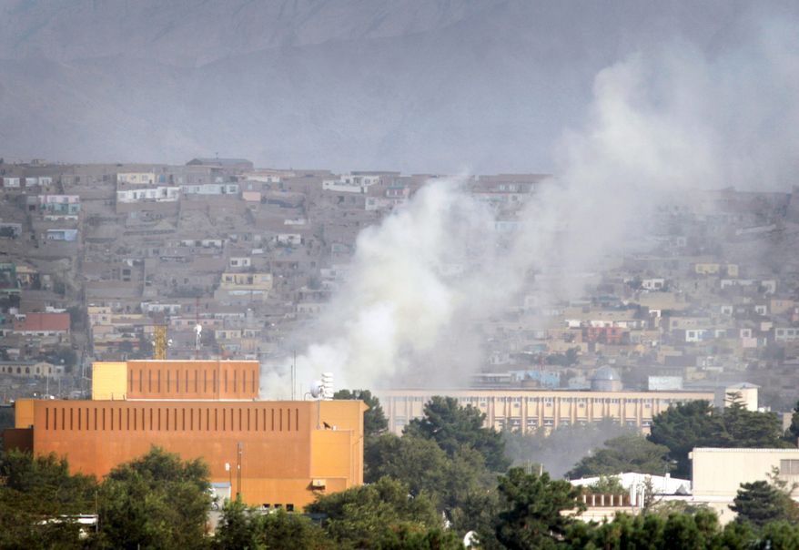 Afghan security forces patrol near the building that was occupied by militants in Kabul in September 2011. Insurgent took over a building to fire on the U.S. Embassy and NATO compounds. An internal report revealed the U.S. diplomatic facilities in Afghanistan have dangerous security lapses. (Associated Press)