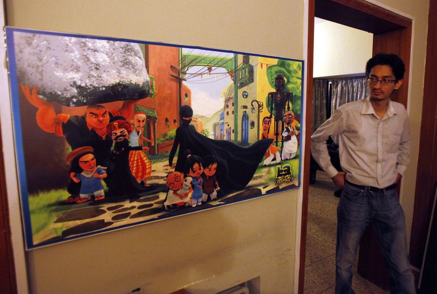 A Pakistani man looks at a poster of the animated "Burka Avenger" series on display at an office in Islamabad on Wednesday, July 24, 2014. (AP Photo/Anjum Naveed)