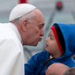 Pope Francis reaches out to kiss a child as he arrives to the Aparecida Basilicia in Aparecida, Brazil, Wednesday, July 24, 2013.  (AP Photo/Domenico Stinellis)