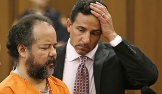 ** FILE ** Ariel Castro, left, stands before a judge with defense attorney Craig Weintraub during Castro&#39;s arraignment on an expanded 977-count indictment Wednesday, July 17, 2013, in Cleveland. Castro is charged with kidnapping and raping three women over a decade in his Cleveland home. Castro pleaded not guilty to 512 counts of kidnapping and 446 counts of rape. (AP Photo/Tony Dejak)