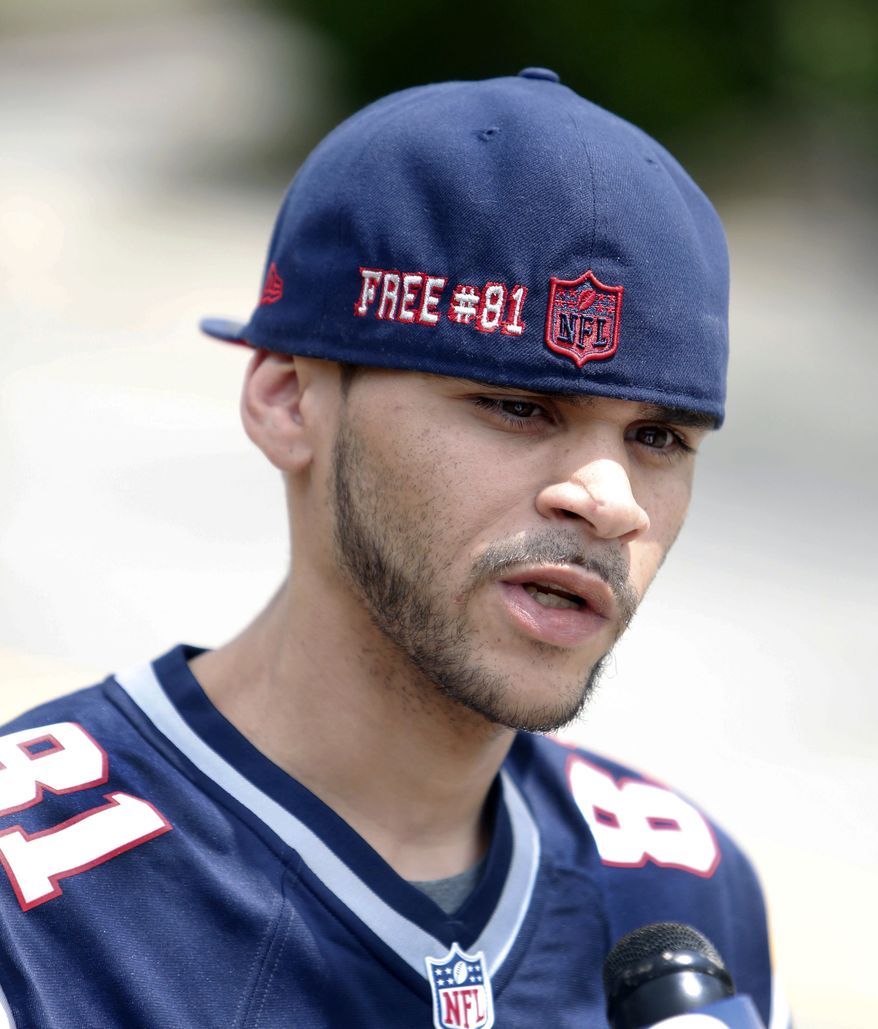 Jonathan Ramos of Hartford, Conn., wearing former an Aaron Hernandez New England Patriots jersey and "Free #81" hat, speaks to reporters outside Attleboro District Court where the former New England Patriots tight end appeared for his probable cause hearing on Wednesday, July 24, 2013, in Attleboro, Mass. Hernandez has pleaded not guilty to murder in the death of Odin Lloyd, a 27-year-old Boston semi-professional football player whose body was found June 17 in an industrial park near Hernandez's home. He had been shot five times. (AP Photo/Bizuayehu Tesfaye)