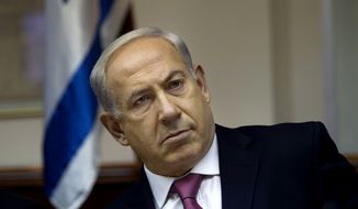 Israeli Prime Minister Benjamin Netanyahu attends the weekly Cabinet meeting in Jerusalem on Sunday, July 28, 2013. Mr. Netanyahu urged his skeptical coalition partners Sunday to agree to free Palestinian prisoners as part of U.S efforts to resume peace talks, calling the deal a &quot;tough decision&quot; that he took for the good of the country. (AP Photo/Ronen Zvulun, Pool)
