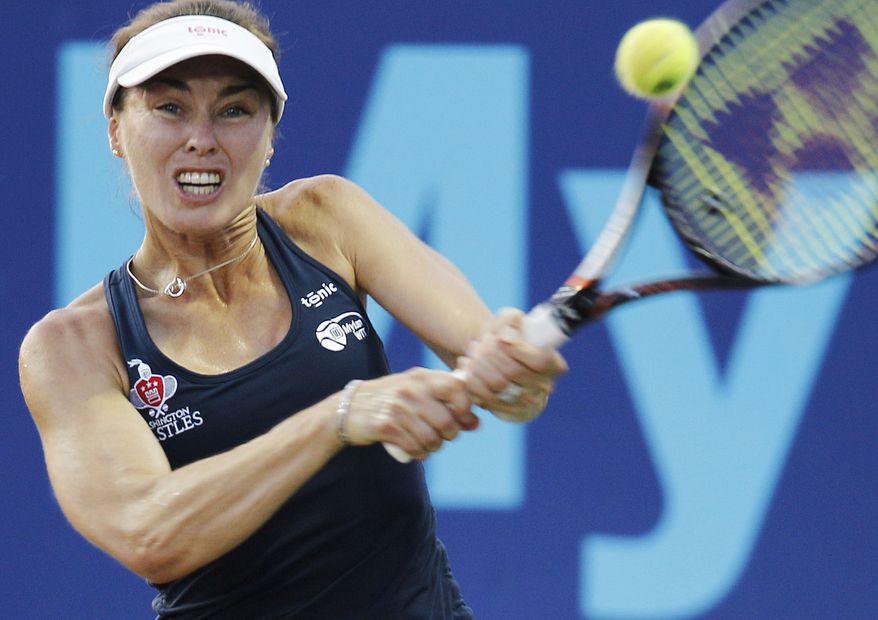 **FILE** Washington Kastles' Martina Hingis hits a backhand to Texas Wild's Eugenie Bouchard during their World Team Tennis singles match Friday, July 19, 2013, in Irving, Texas. (AP Photo/Kim Johnson Flodin)