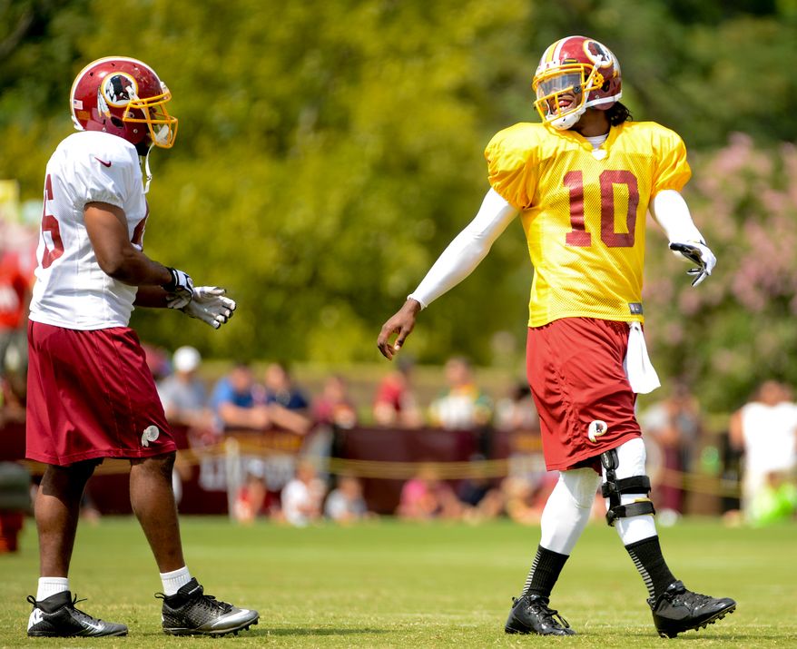 Washington Redskins quarterback Robert Griffin III (10) shares a laugh with Washington Redskins running back Alfred Morris (46), left, during afternoon practice at the Bon Secours Washington Redskins Training Center, Richmond, Va., Tuesday, July 30, 2013. (Andrew Harnik/The Washington Times)