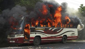 A bus goes up in flames in Bogra, some 120 kilometers (75 miles) north of Dhaka, Bangladesh, on Aug. 1, 2013, after being set on fire by activists in Bangladesh&#39;s Jamaat-e-Islami party after the Bangladesh high court disqualified the party from taking part in the next general election. The High Court panel ruled that the country&#39;s largest Islamic party’s regulations violate the constitutional provision of secularism. (Associated Press)