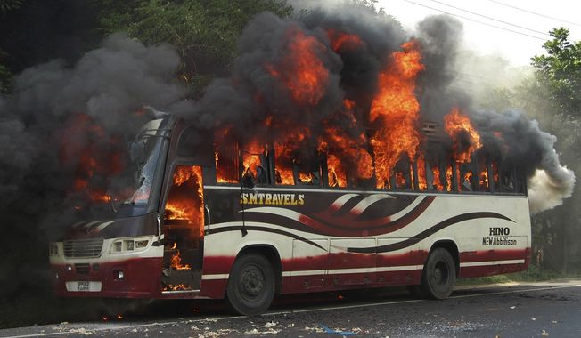 A bus goes up in flames in Bogra, some 120 kilometers (75 miles) north of Dhaka, Bangladesh, on Aug. 1, 2013, after being set on fire by activists in Bangladesh&#x27;s Jamaat-e-Islami party after the Bangladesh high court disqualified the party from taking part in the next general election. The High Court panel ruled that the country&#x27;s largest Islamic party’s regulations violate the constitutional provision of secularism. (Associated Press)