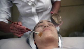 Salon owner Shizuka Bernstein gives what she calls a Geisha Facial to Mari Miyoshi at Shizuka New York skin care in New York. The facial, which Bernstein has been offering for five years, is a traditional Japanese treatment using imported Asian nightingale excrement mixed with rice bran. (AP Photo/Mary Altaffer)