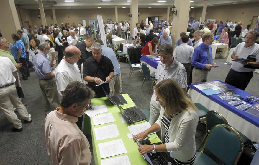 **FILE** People fill up the room at the job fair on July 15, 2013, in South Burlington, Vt. (Associated Press)