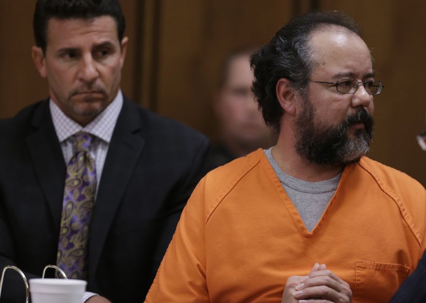 ** FILE ** Ariel Castro looks at Michelle Knight, one of three women whom he was convicted of holding captive, as he speaks during the sentencing phase of his trial on Thursday, Aug. 1, 2013, in Cleveland. (AP Photo/Tony Dejak)