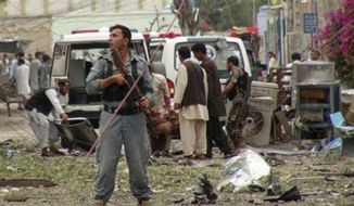 Security officials conduct investigation at the scene of suicide bomb attacks in Jalalabad, Afghanistan, Saturday, 3, 2013. Three suicide attackers killed at least nine civilians, most of them children, in a botched attack Saturday on the Indian consulate in an eastern Afghan city near the border with Pakistan, security officials said. (Associated Press)