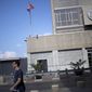 A man walks past the U.S. Embassy in Tel Aviv, Israel, Sunday, Aug. 4, 2013. The threat of a terrorist attack led to the weekend closure of 21 U.S. embassies and consulates in the Muslim world and a global travel warning to Americans, the first such alert since an announcement before the 10th anniversary of the Sept. 11 strikes. (AP Photo/Ariel Schalit)