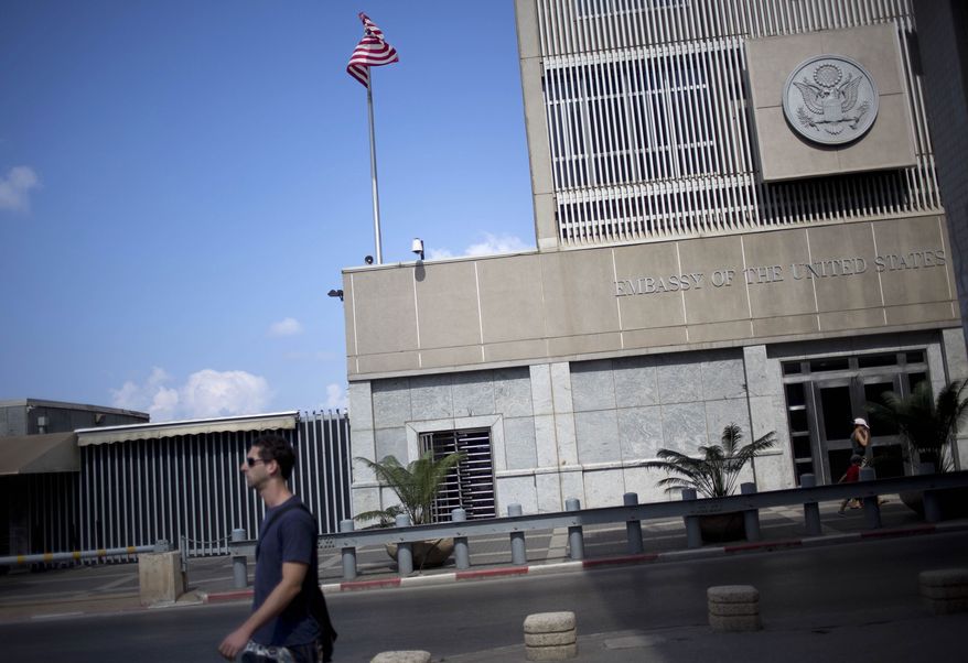 A man walks past the U.S. Embassy in Tel Aviv, Israel, Sunday, Aug. 4, 2013. The threat of a terrorist attack led to the weekend closure of 21 U.S. embassies and consulates in the Muslim world and a global travel warning to Americans, the first such alert since an announcement before the 10th anniversary of the Sept. 11 strikes. (AP Photo/Ariel Schalit)