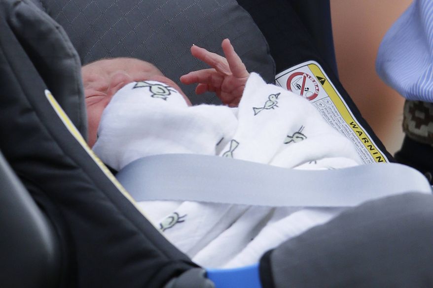 ** FILE ** In this Tuesday, July 23, 2013, file photo, Prince George of Cambridge lays in a car seat as his parents, Britain's Prince William and Kate, duchess of Cambridge, leave St. Mary's Hospital exclusive Lindo Wing, in London where the duchess gave birth on Monday, July 22. (AP Photo/Alastair Grant, file)