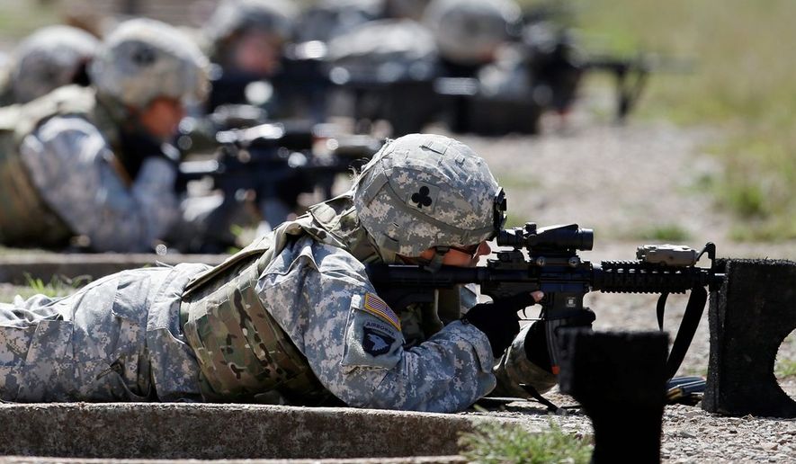 Female soldiers test body armor while training in Fort Campbell, Ky. According to a review of statements, the military may be lowering some physical standards for male and female troops on the argument that certain tasks are outdated or irrelevant. (Associated Press)