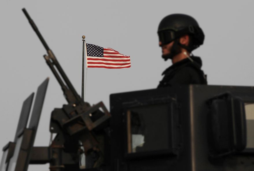 A Bahraini armored personnel vehicle reinforces U.S. Embassy security just outside a gate to the embassy building in Manama, Bahrain, on Aug. 4, 2013. Security forces close access roads, put up extra blast walls and beef up patrols near some of the 21 U.S. diplomatic missions in the Muslim world that Washington ordered closed for the weekend over a "significant threat'' of an al Qaeda attack. (Associated Press)