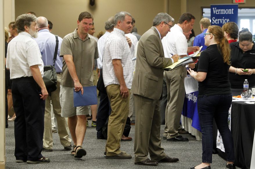**FILE** People line up at the job fair in South Burlington, Vt., on  July 15, 2013. (Associated Press)