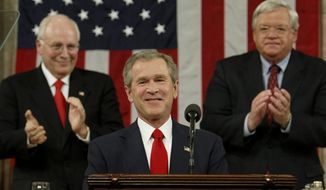 President Bush is applauded by Vice President Dick Cheney (left) and House Speaker Dennis Hastert, of Ill. while delivering his State of the Union address to a joint session of Congress in 2004. (Associated Press)