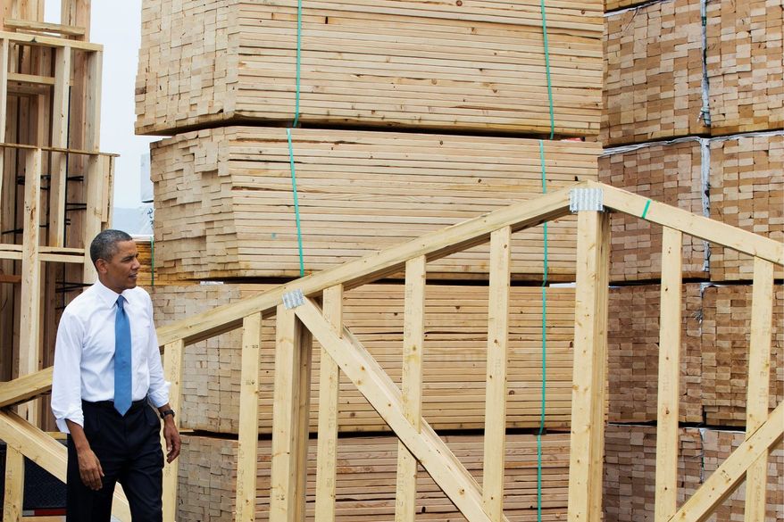 President Obama tours the home framing assembly area at Erickson Construction in Chandler, Ariz., on Tuesday. Mr. Obama annouced support of a Senate bill that would eliminate mortgage giants Fannie Mae and Freddie Mac. (Associated Press)