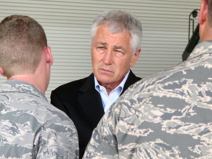 **FILE** Defense Secretary Chuck Hagel talks with Air Force personnel at Joint Base Charleston near Charleston, S.C., on July 17, 2013, the last day of a three-day trip to visit bases in the Carolinas and Florida. (Associated Press)