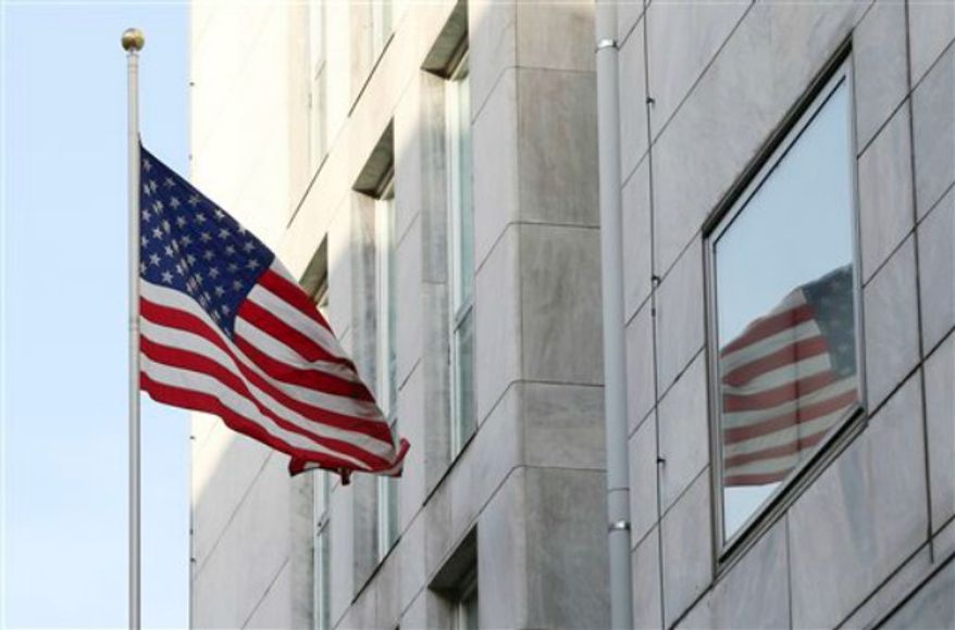 An American flag flies outside the U.S. Consulate in Milan, Italy, Tuesday, Aug. 6, 2013. Anti-terrorism police in Milan say the city's U.S. Consulate has been evacuated after receiving a letter containing a bomb threat. (AP Photo/Antonio Calanni)